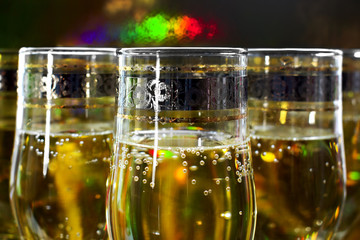 Glasses of champagne on bright festive background. New year