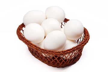 A basket of eggs on white background