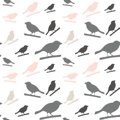 Birds pattern. Vector seamless pattern with hand drawn silhouettes of birds on a tree branch.