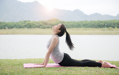 Portrait of beutiful young woman practicing yoga outdoor.