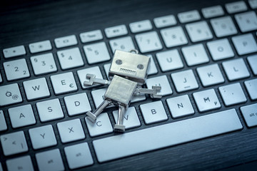 Roboter auf Tastatur, Methapher für Chatbot / Socialbot, Algorithmen und künstliche Intelligenz