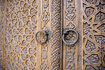 An old wood door with metal handle. Details of Muslim architecture.