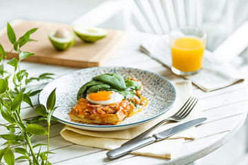Scrambled eggs on meat with fried potatoes and toast