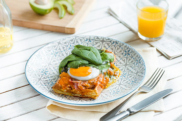 Scrambled eggs on meat with fried potatoes and toast