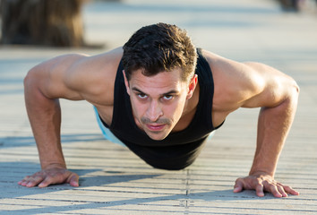 Fototapeta premium Athletic man doing press up exercises
