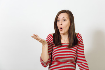 Pretty European young worried and pensive brown-haired woman with healthy clean skin, dressed in casual red and grey clothes lost in thought and conjectures, on a white background. Emotions concept.