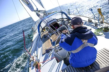Printed kitchen splashbacks Sailing Skagen, Denmark, 31 July 2017:  A lone sailor behind the helm on the North Sea