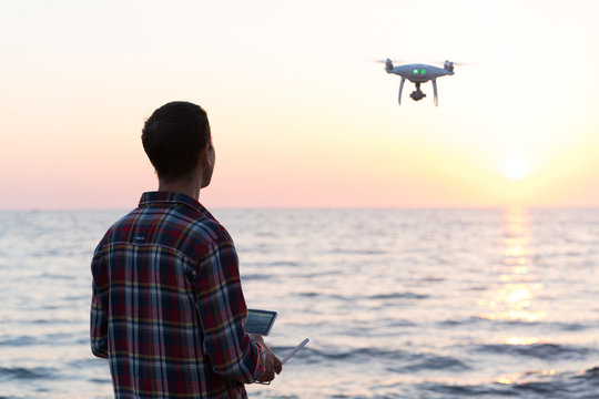 Man Launches A Drone On The Beach