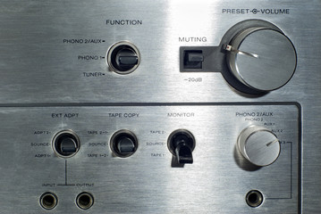 Front panel section of audio power amplifier with switches and knobs