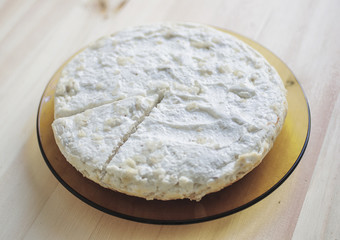 Cottage cheese casserole in a plate on a wooden table