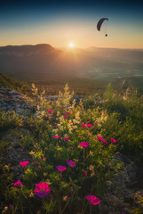 Paraglide silhouette flying over the Crimea mountains