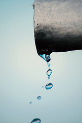 Water flows from the pipe, macro
