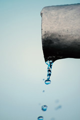 Obraz na płótnie Canvas Water flows from the pipe, macro
