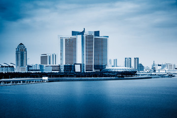Fototapeta na wymiar modern city waterfront downtown skyline, blue tone image
