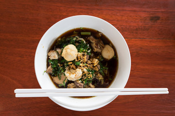 noodle in white bowl, wood background