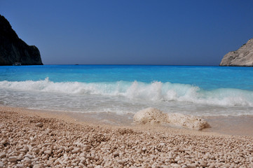 white sand and stone with waves sea horizon 