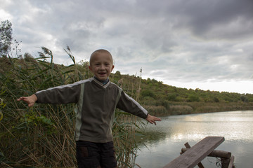 boy laughing at the lake shore