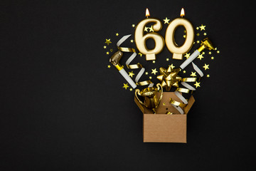Number 60 gold celebration candle and gift box background