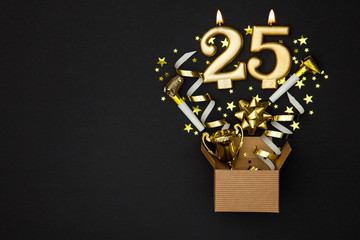 Number 25 gold celebration candle and gift box background