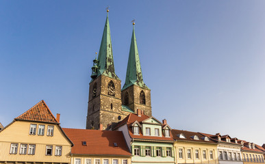 Fototapeta premium Church towers over a row of houses in Quedlinburg