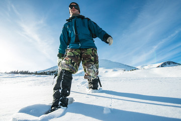 Fototapeta na wymiar climber with an ice ax walks in the snowy mountains