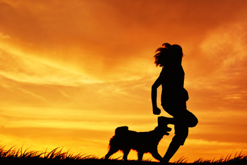 Silhouette women and dog playing at sky sunset in holiday