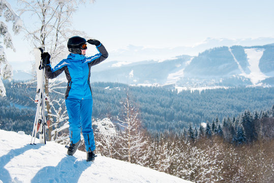 Full length shot of a woman skier enjoying stunning scenery in the mountains looking away at winter ski resort Bukovel copyspace