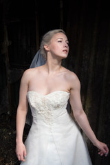 Young bride in the urban decay environment of Platt's Eyot Island in Hampshire UK