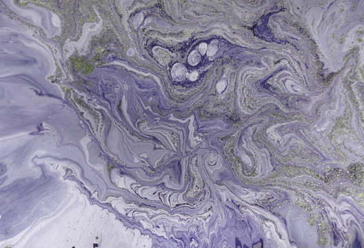 Marbled purple abstract background with golden sequins. Liquid marble ink pattern.