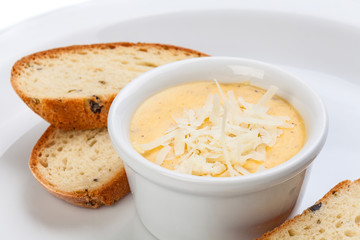 Close-up of white sauce in bowl and bread, isolated on white background.