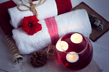 SPA consist from towels, candles, flowers, and aromatherapy water