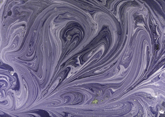 Marbled purple abstract background with golden sequins. Liquid marble ink pattern.
