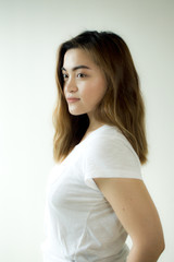 A portrait of a woman wearing a white shirt