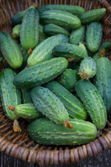 cucumbers in a basket on wooden surface