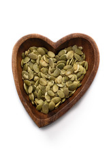 Raw pumpkin seeds, food background, top view