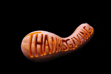 lettering word 'Thanksgiving' on a pumpkin