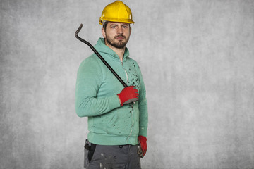 Worker holding a crowbar in his hand