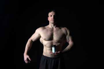 Fototapeta na wymiar Athletic bodybuilder isolated on black background.
