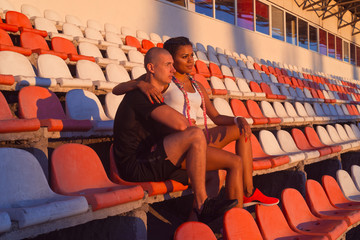 A guy and a girl at the stadium are engaged in sports, lifestyle
