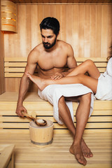 Beautiful couple relaxing in SPA sauna room