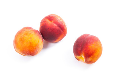 Group of ripe peach fruit isolated on white background.