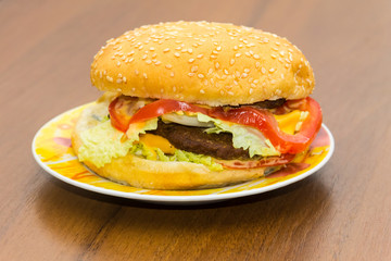 Delicious hamburger or sandwich on plate on wooden table