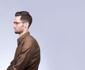 Portrait of a man in profile with a free space. Sad young man with drooping eyes. Stylish appearance