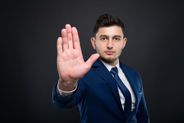 Attractive businessman rising his palm up