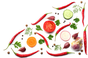 mix red hot chili peppers with parsley and sliced cucumber and carrot isolated on white background top view