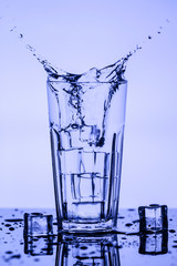 Splashing water with ice cubes