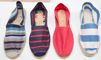 brightly colored traditional spanish slippers shoes espadrilles for sale in a shop in the French Basque Country