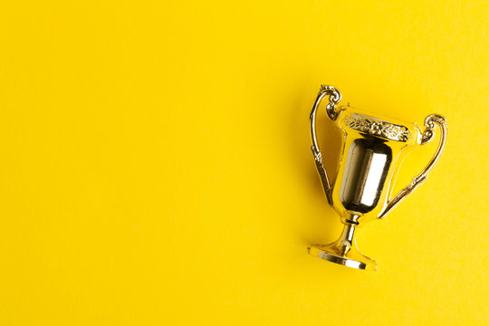 Gold Winners Achievement Trophy On A Yellow Background