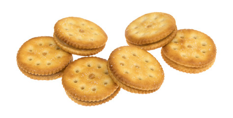 Several roasted peanut butter crackers isolated on a white background.