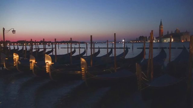 Gondolas moored at the quay of San Marco before dawn. Venice, Italy